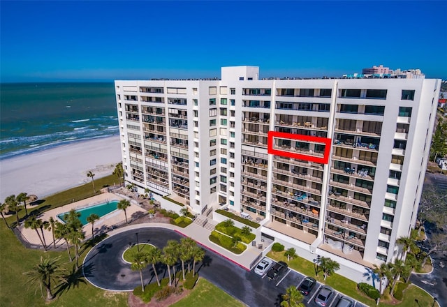 view of building exterior featuring a view of the beach and a water view