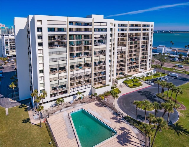 view of property featuring a community pool and a water view