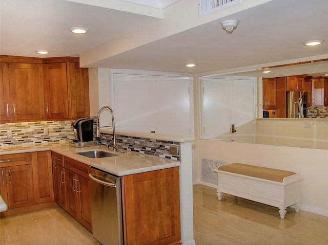 kitchen featuring tasteful backsplash, sink, light tile patterned floors, and appliances with stainless steel finishes