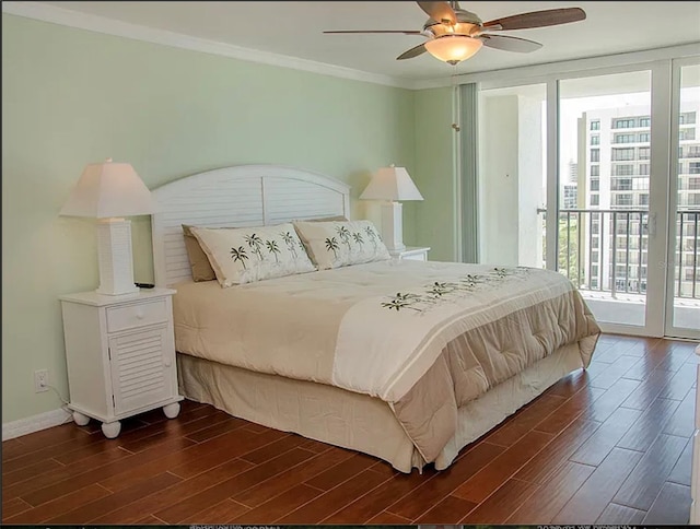 bedroom featuring dark hardwood / wood-style floors, ornamental molding, access to exterior, and expansive windows