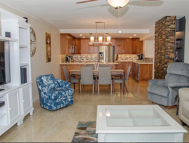 tiled living room featuring crown molding and ceiling fan