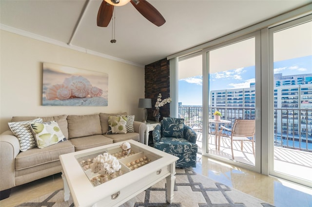 living room featuring expansive windows, ceiling fan, and ornamental molding