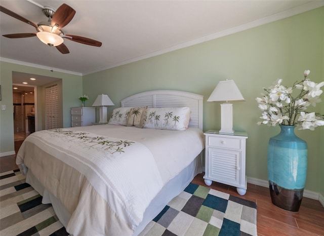 bedroom with ceiling fan, hardwood / wood-style floors, ensuite bathroom, ornamental molding, and a closet