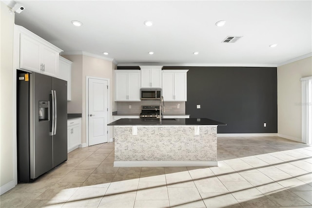 kitchen featuring an island with sink, appliances with stainless steel finishes, white cabinets, and crown molding