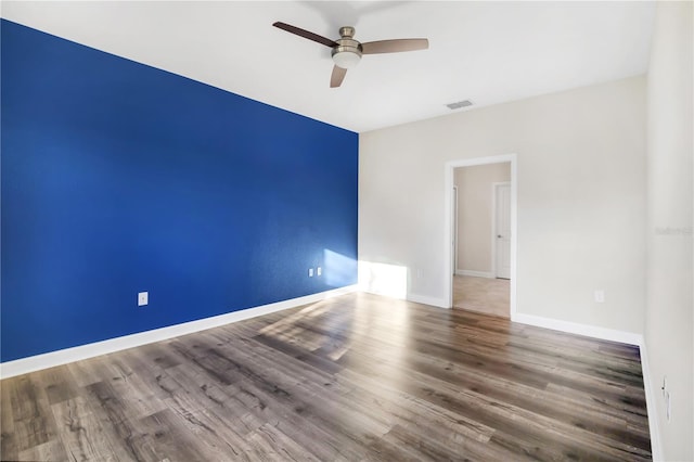 empty room featuring hardwood / wood-style flooring and ceiling fan