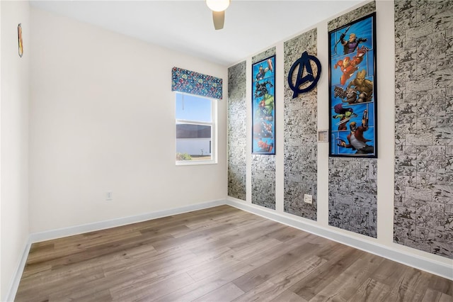 unfurnished room featuring ceiling fan and wood-type flooring