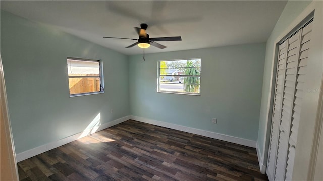 unfurnished bedroom with ceiling fan, dark hardwood / wood-style flooring, and a closet