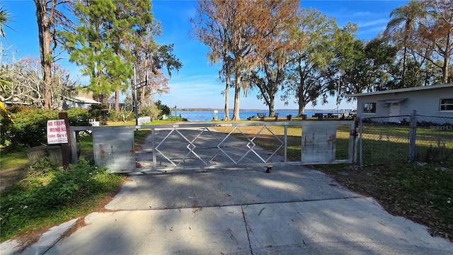 view of gate with a water view