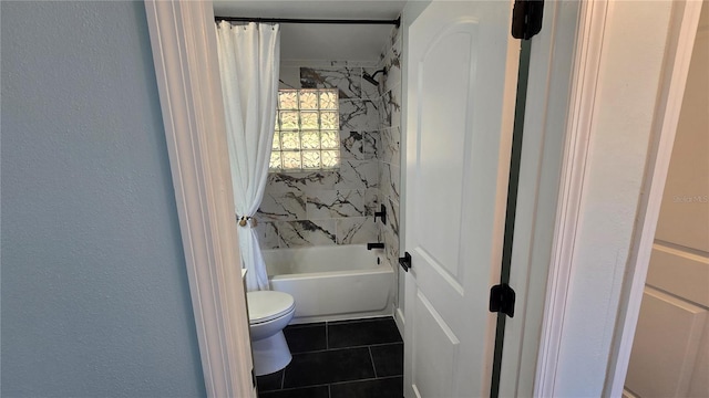 bathroom featuring toilet, tile patterned flooring, and shower / tub combo