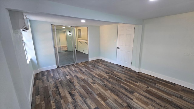 unfurnished bedroom with dark hardwood / wood-style flooring and a closet