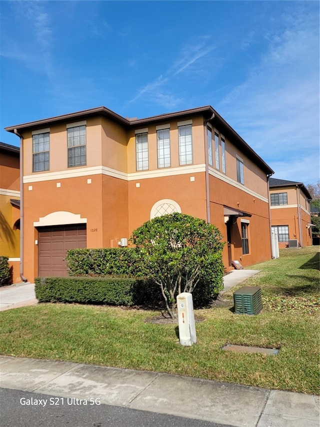 view of front of property featuring a garage and a front yard