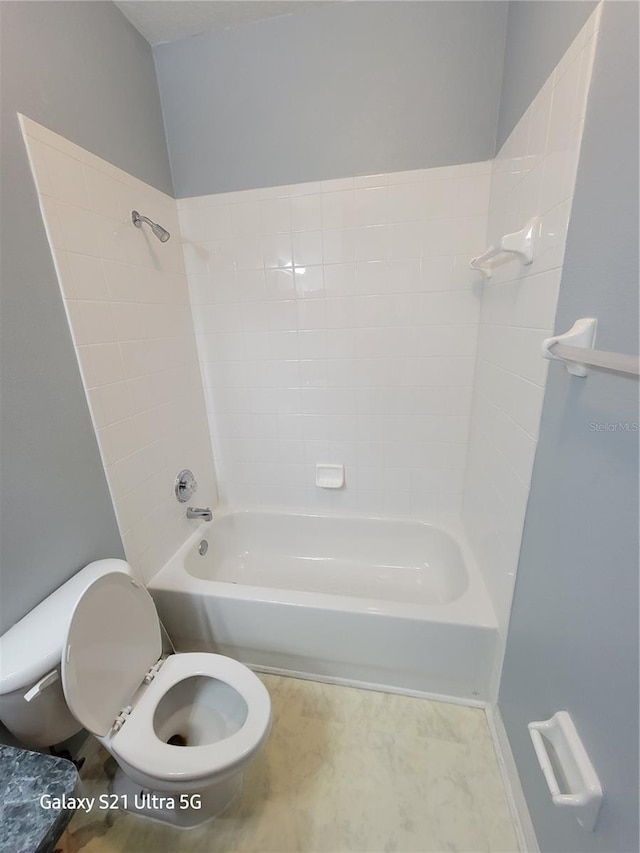 bathroom with toilet and tiled shower / bath combo