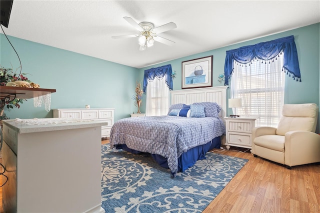 bedroom featuring ceiling fan and light hardwood / wood-style flooring