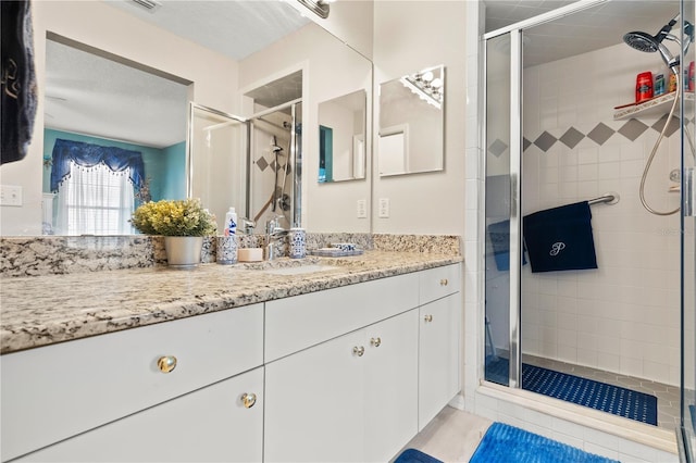 bathroom featuring vanity and an enclosed shower