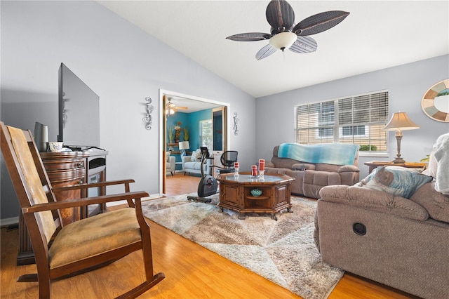 living room featuring wood-type flooring, vaulted ceiling, and ceiling fan