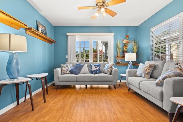 living room featuring ceiling fan and light wood-type flooring