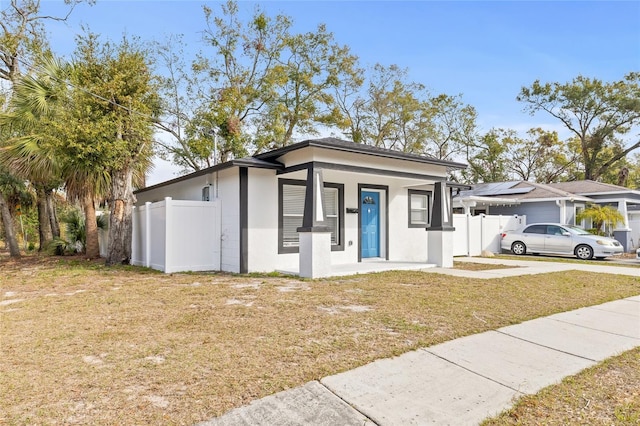 view of front of home with a porch and a front lawn