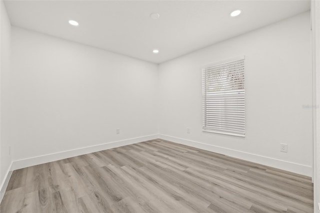 unfurnished room with light hardwood / wood-style floors