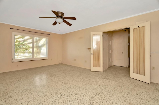 spare room with crown molding and ceiling fan