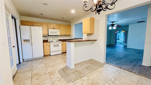 kitchen featuring light brown cabinetry, sink, kitchen peninsula, white appliances, and ceiling fan with notable chandelier