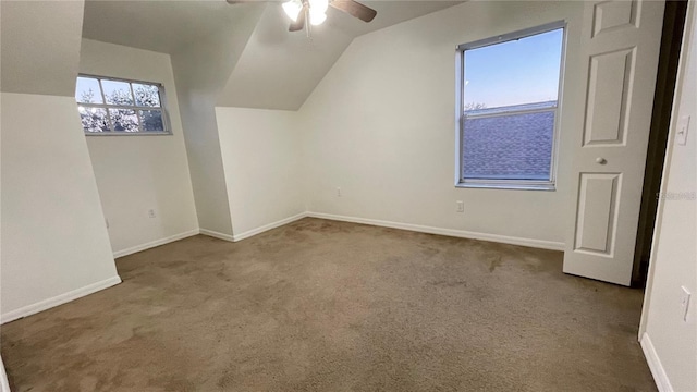 additional living space featuring ceiling fan, light colored carpet, and lofted ceiling