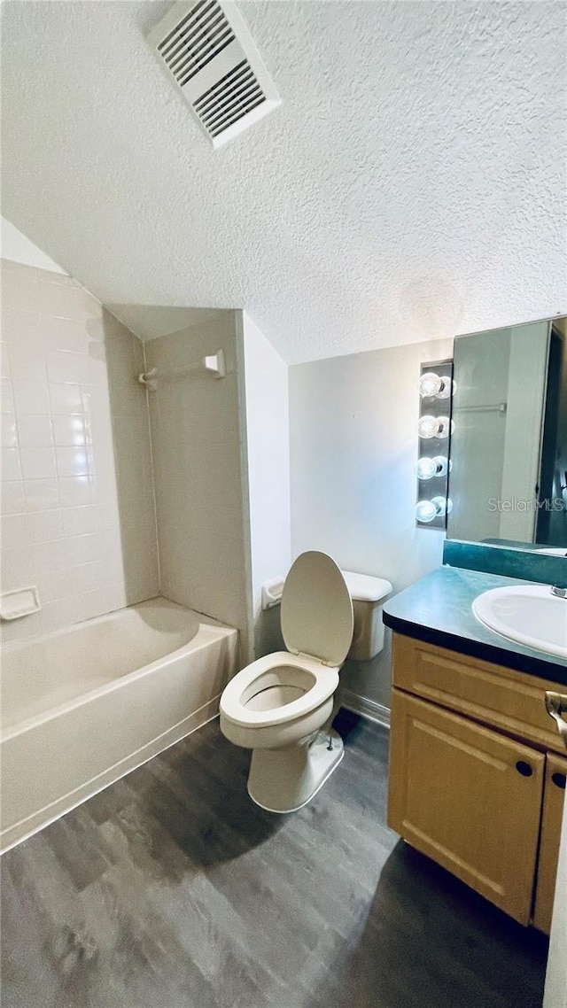 full bathroom featuring shower / tub combination, wood-type flooring, toilet, and vanity