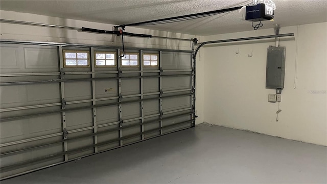 garage with a garage door opener and electric panel