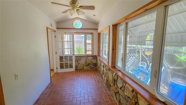 unfurnished sunroom featuring ceiling fan and vaulted ceiling