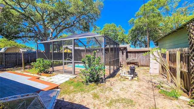 view of yard featuring a swimming pool side deck and glass enclosure