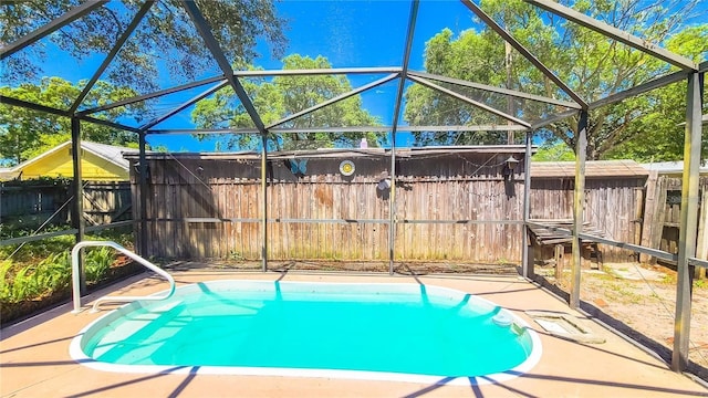 view of swimming pool featuring glass enclosure