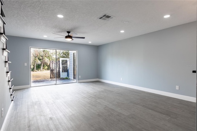 empty room featuring wood-type flooring, a textured ceiling, and ceiling fan