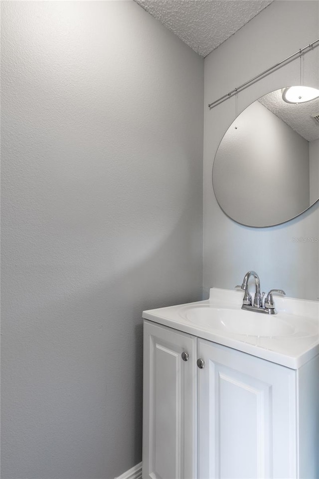 bathroom with vanity and a textured ceiling