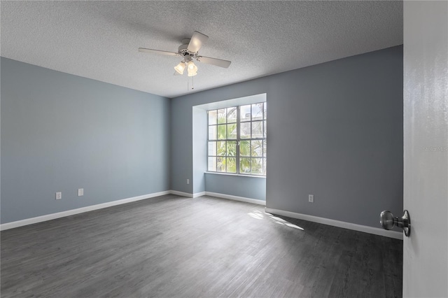 empty room with a textured ceiling, dark hardwood / wood-style floors, and ceiling fan