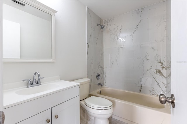 full bathroom with tiled shower / bath, vanity, and toilet