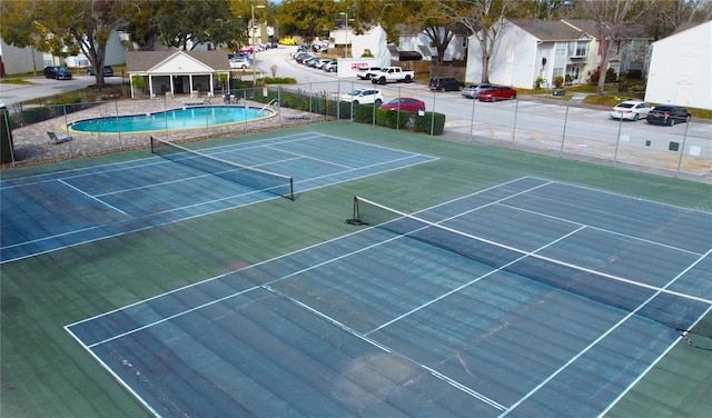 view of sport court with a community pool