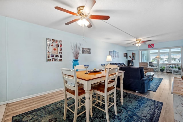 dining room featuring ceiling fan, a textured ceiling, and light wood-type flooring