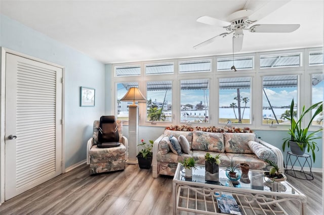 living room featuring wood-type flooring and ceiling fan