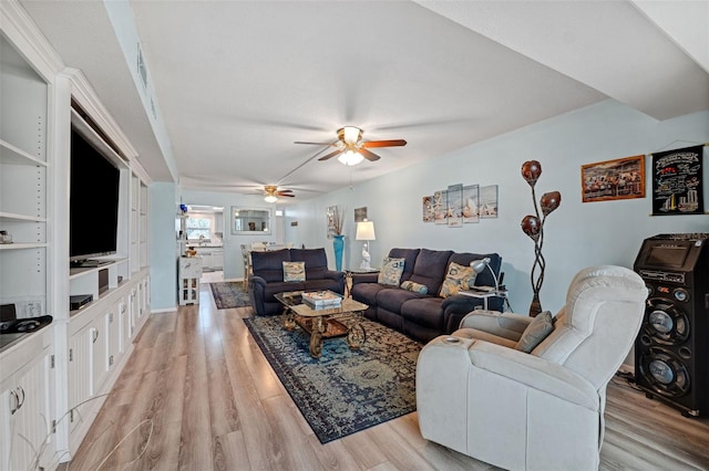 living room featuring light hardwood / wood-style floors and ceiling fan