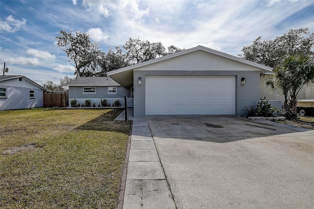 ranch-style house featuring a garage and a front lawn