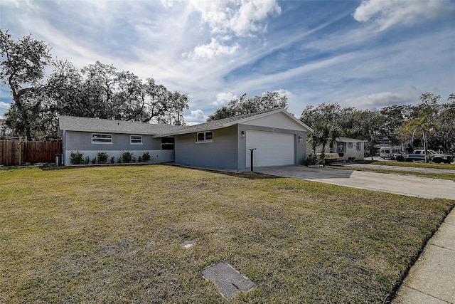 ranch-style house with a garage and a front lawn