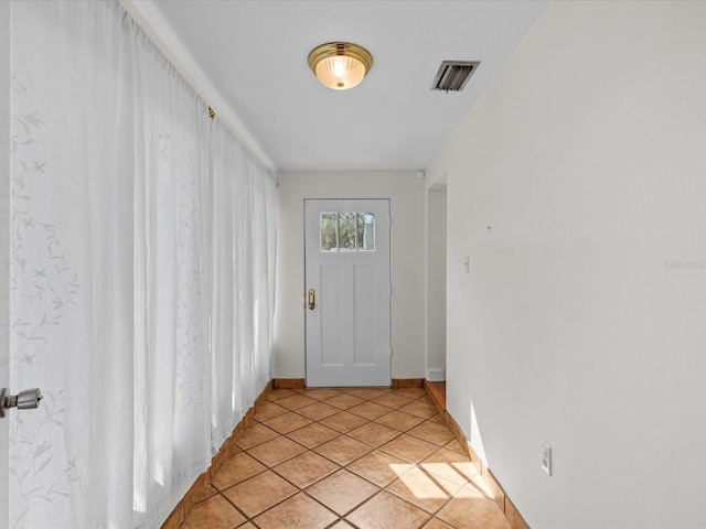 entryway with light tile patterned floors