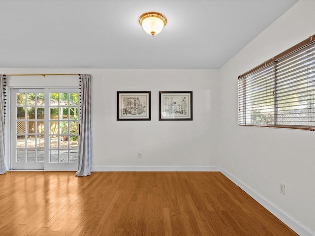 unfurnished room with a wealth of natural light and light hardwood / wood-style floors