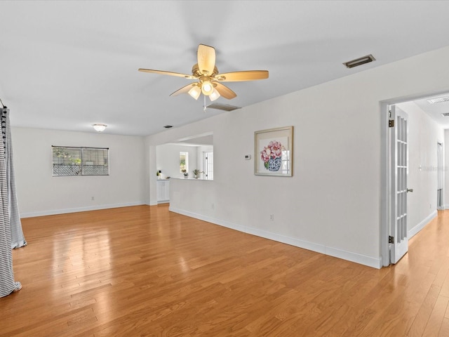 unfurnished living room featuring ceiling fan and light wood-type flooring