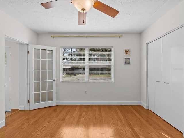 interior space with a closet, light hardwood / wood-style flooring, and a textured ceiling