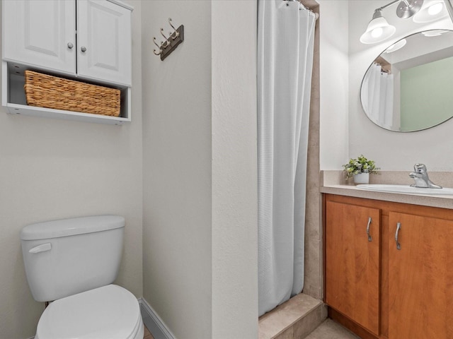 bathroom with vanity, toilet, and curtained shower