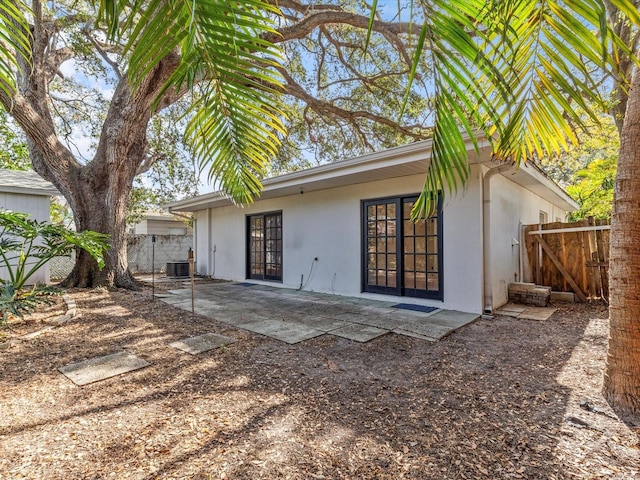 back of property featuring french doors, a patio area, and central air condition unit