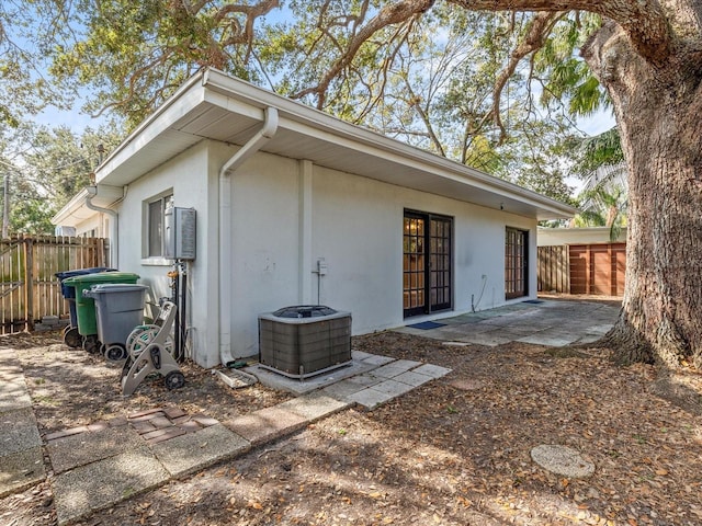 rear view of property with central AC and a patio