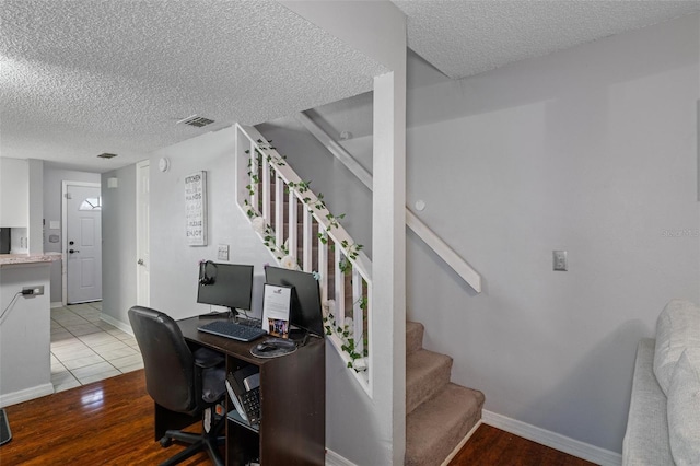 office space with a textured ceiling and light wood-type flooring