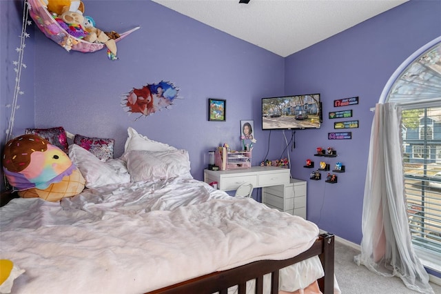 bedroom with carpet and a textured ceiling