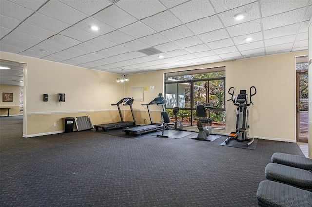 exercise room with a paneled ceiling